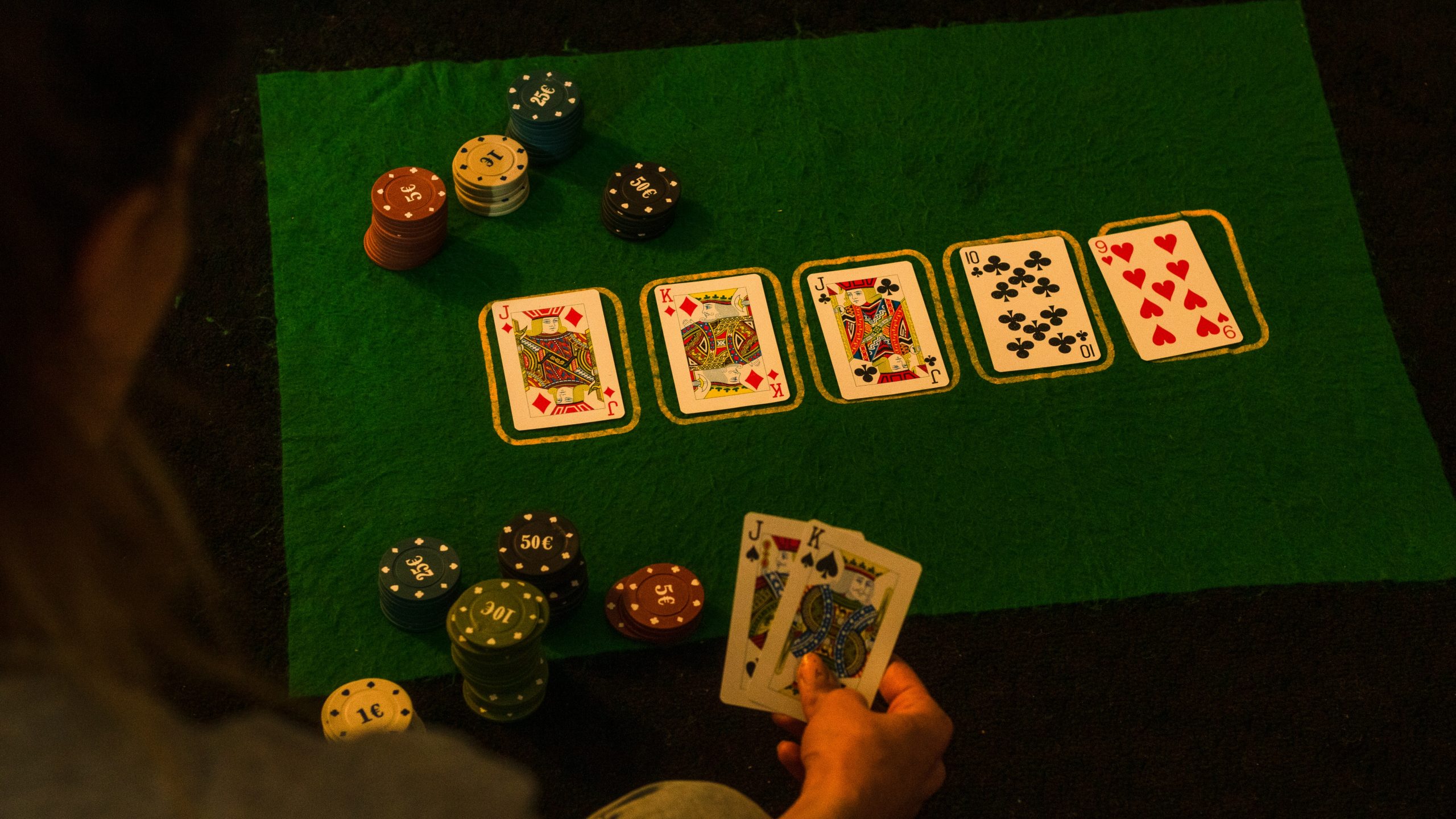 Playing cards and chips on green table