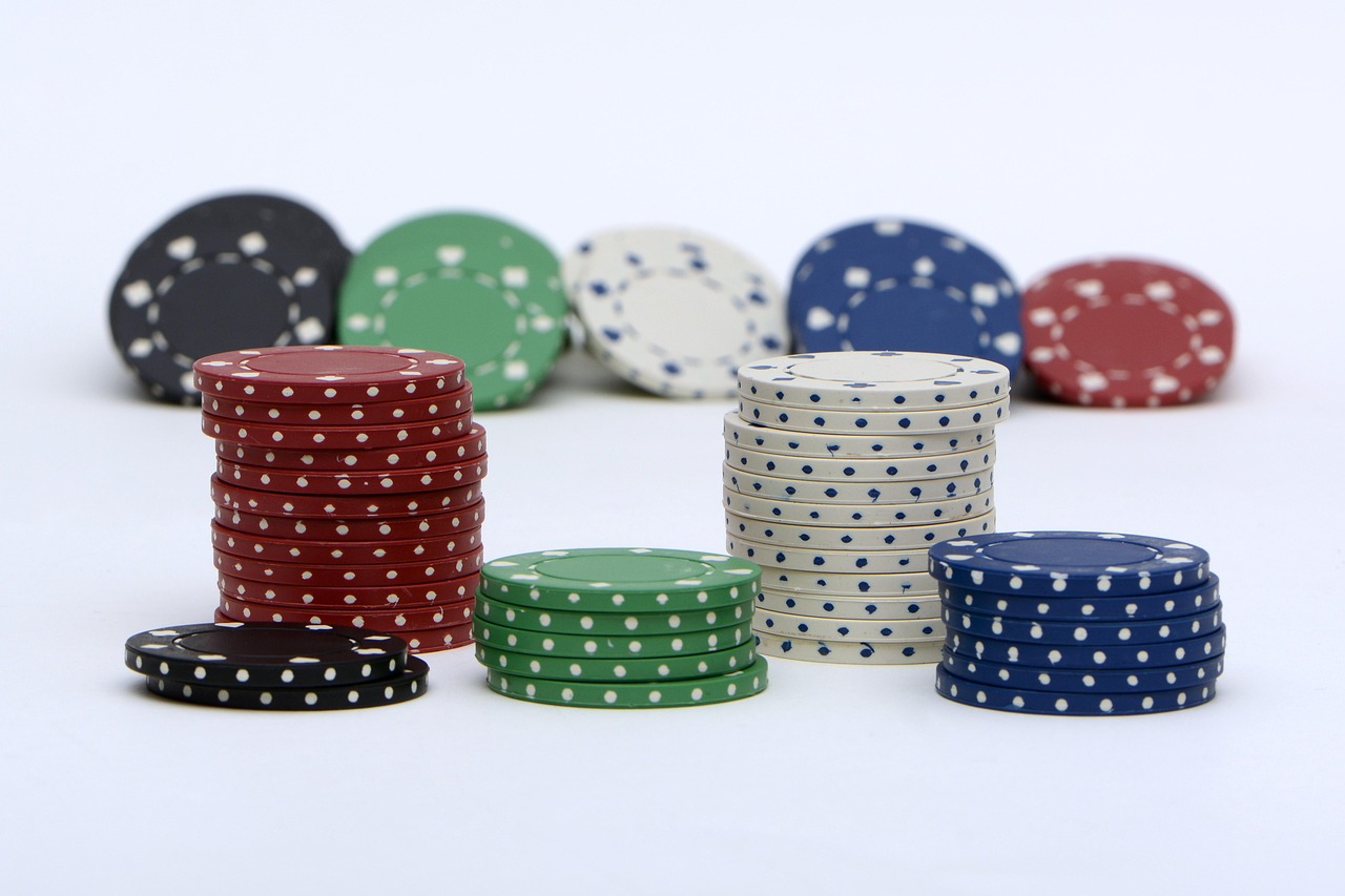 Poker chips stacked on white surface