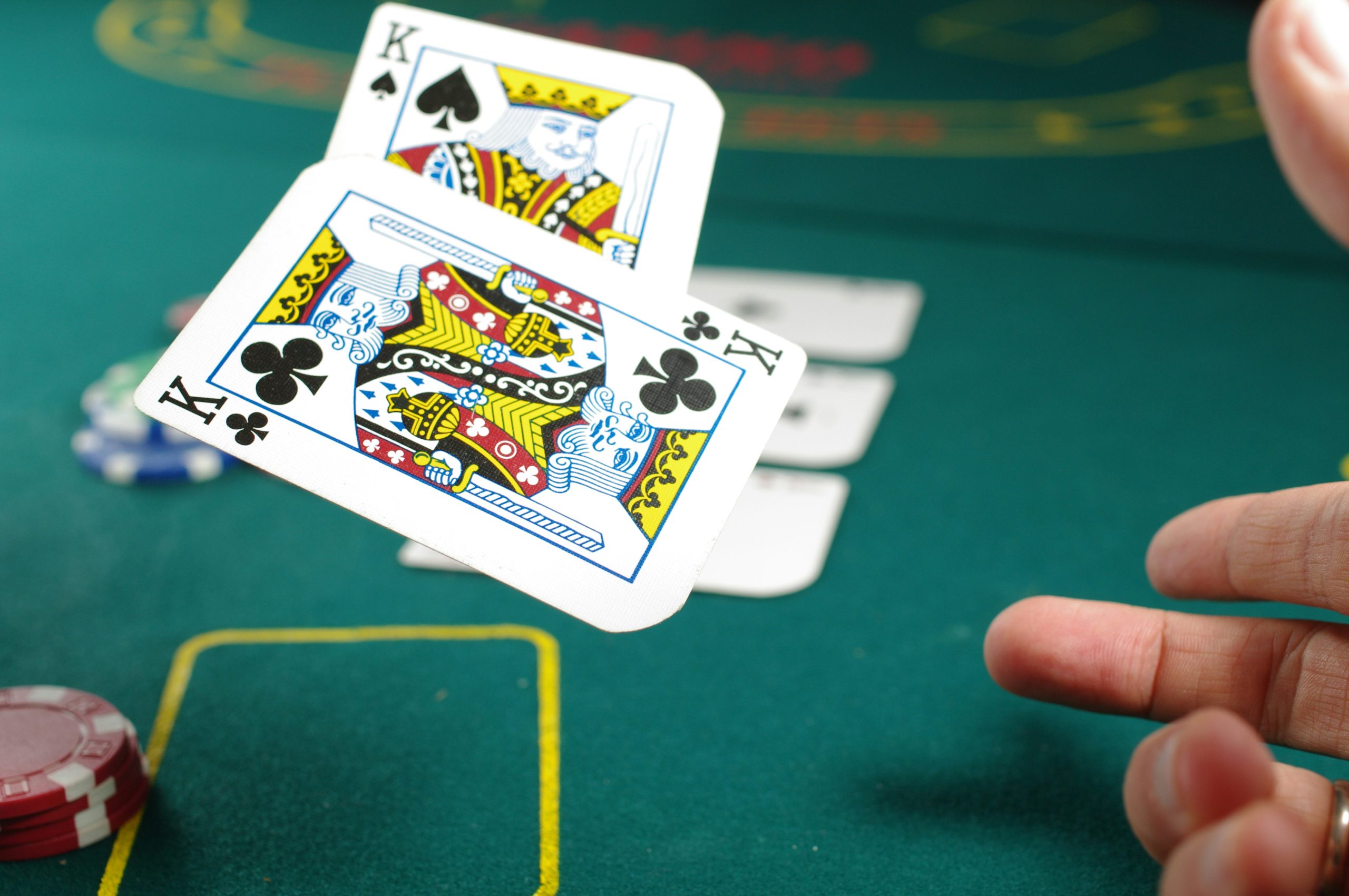 Poker player throwing kings on table
