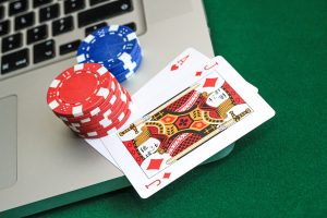 Laptop with playing cards and chips