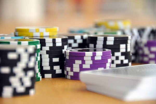 Different coloured poker chips and playing cards