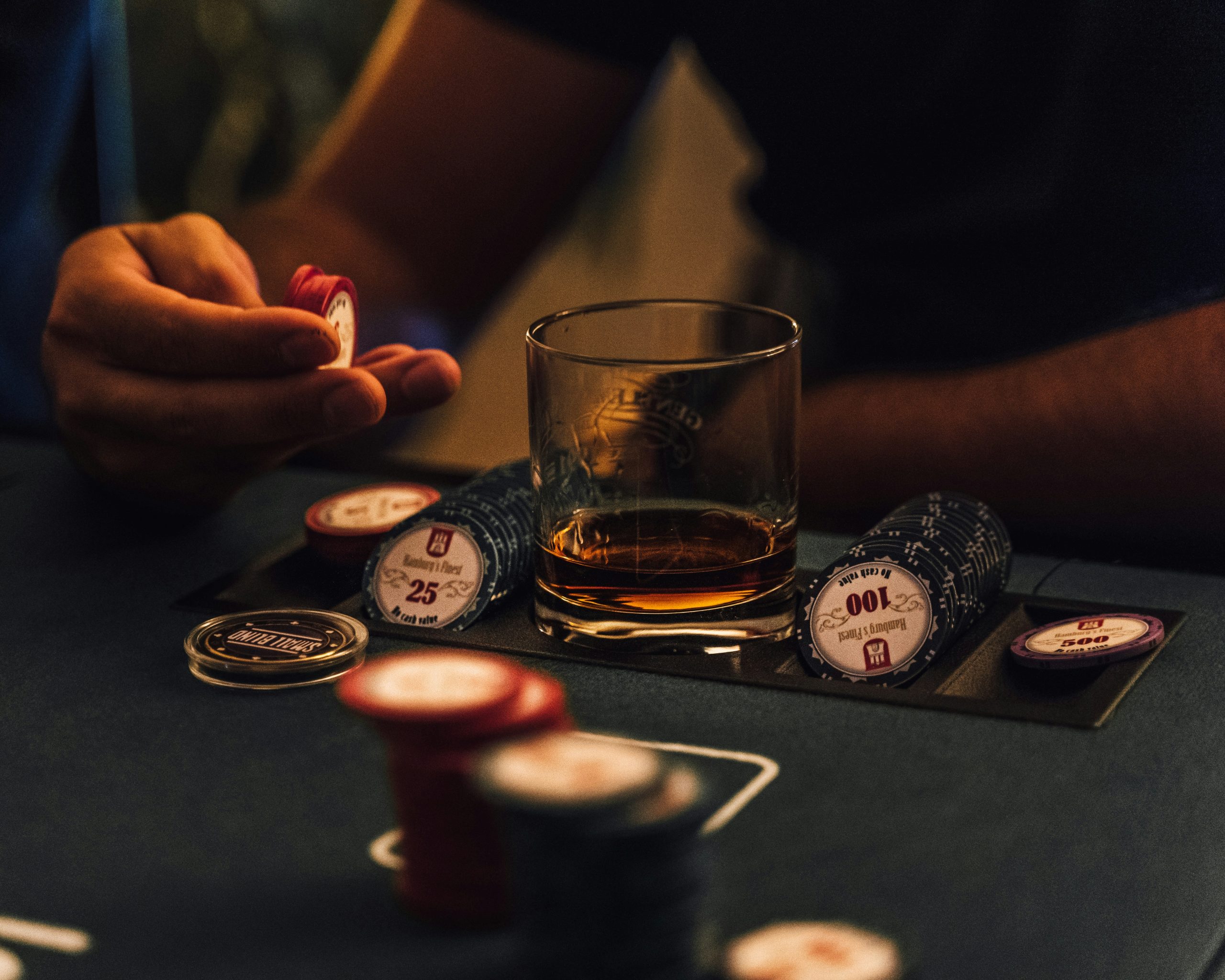 Poker player with glass of whiskey